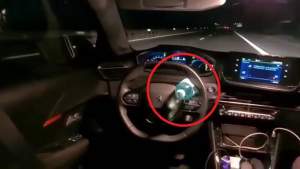 Pericol public. Un șofer a blocat volanul cu o sticlă și s-a mutat pe bancheta din spate, în timp ce mașina mergea cu viteză pe autostradă (VIDEO)